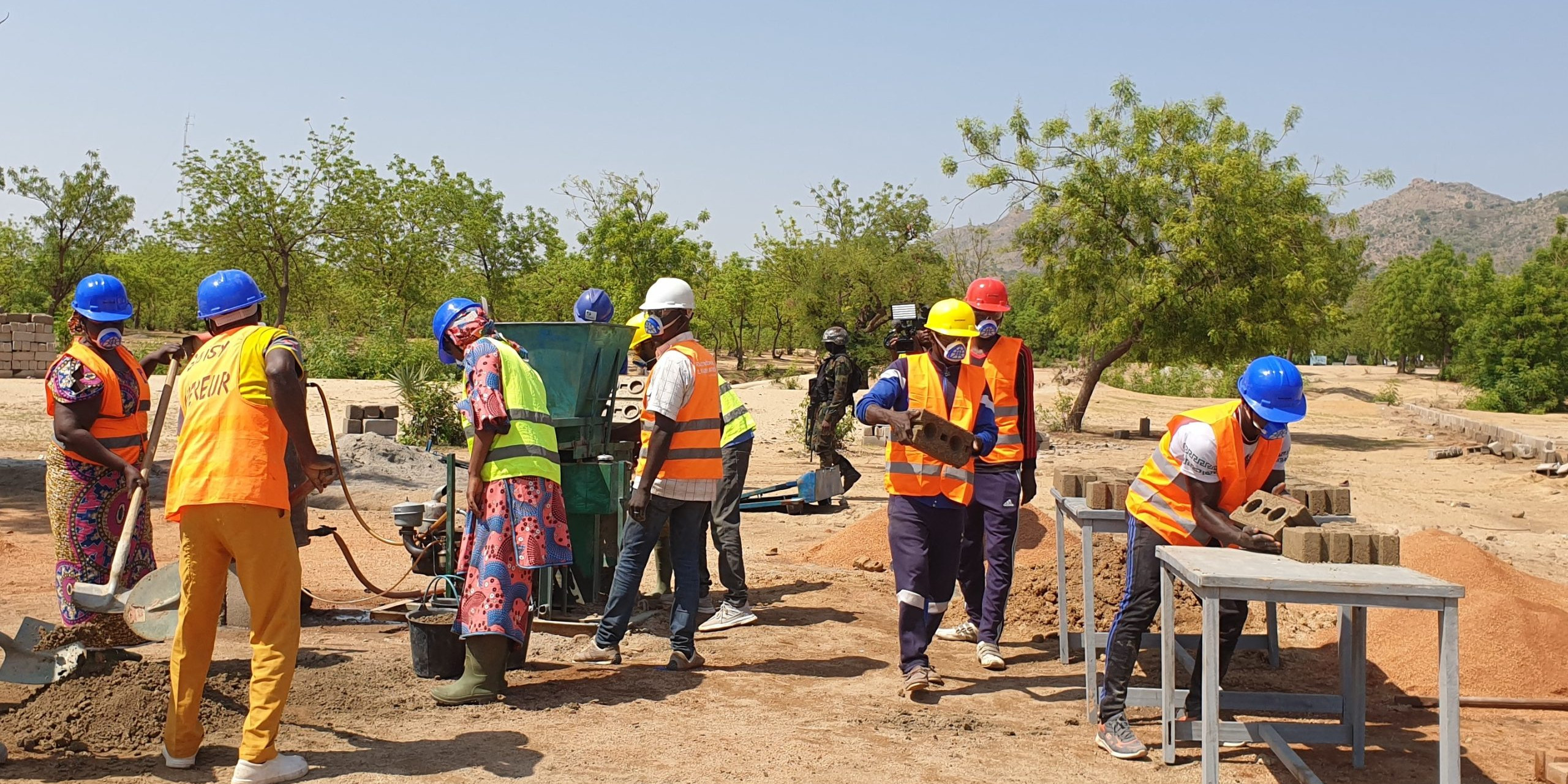 Youth and women producing stabilized earth bricks with AJDEC youth association in Mora, Far North Cameroon