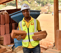 Eric Andela showing low-carbon bricks produced by the Keramos Cameroon, a small-scale enterprise making eco-construction materials and ceramics