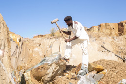 Artisanal and small-scale miner breaking stones in a quarry site in Dambwa in Livingstone district Zambia