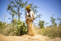 Artisanal and small-scale miner sieving sand for construction at a mining site in Kitwe, Zambia