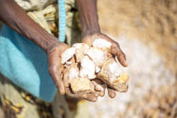 Artisanal and small-scale miner displaying mined silica on the outskirts of Kitwe, Zambia