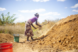 Artisanal and small-scale miner sieving sand for construction at a mining site in Kitwe, Zambia