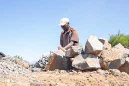 Artisanal and small- scale miner breaking stones used for construction in Dambwa in Livingstone district Zambia