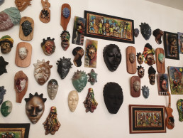 Clay mask art on display in a tourist store in Jamaica