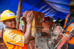 Showing a brick freshly pressed from the machine