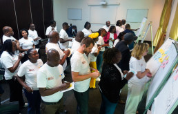 Participants engage in an interactive session to build the structure of the manual, beginning with individual reflections and collaboratively fleshing out chapter topics using post-it notes.
