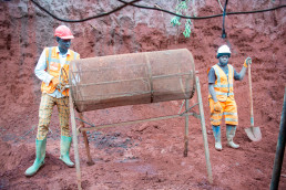 Trainees operating the rotary sieve to prepare the soil