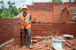 Worker holding a brick on the construction site