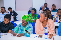 Artisanal miners from the Tanga and Geita regions listen attentively during a workshop session