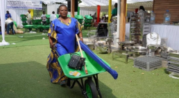 A beneficiary from an artisanal and small-scale mining enterprise receives materials and equipment during the handover ceremony