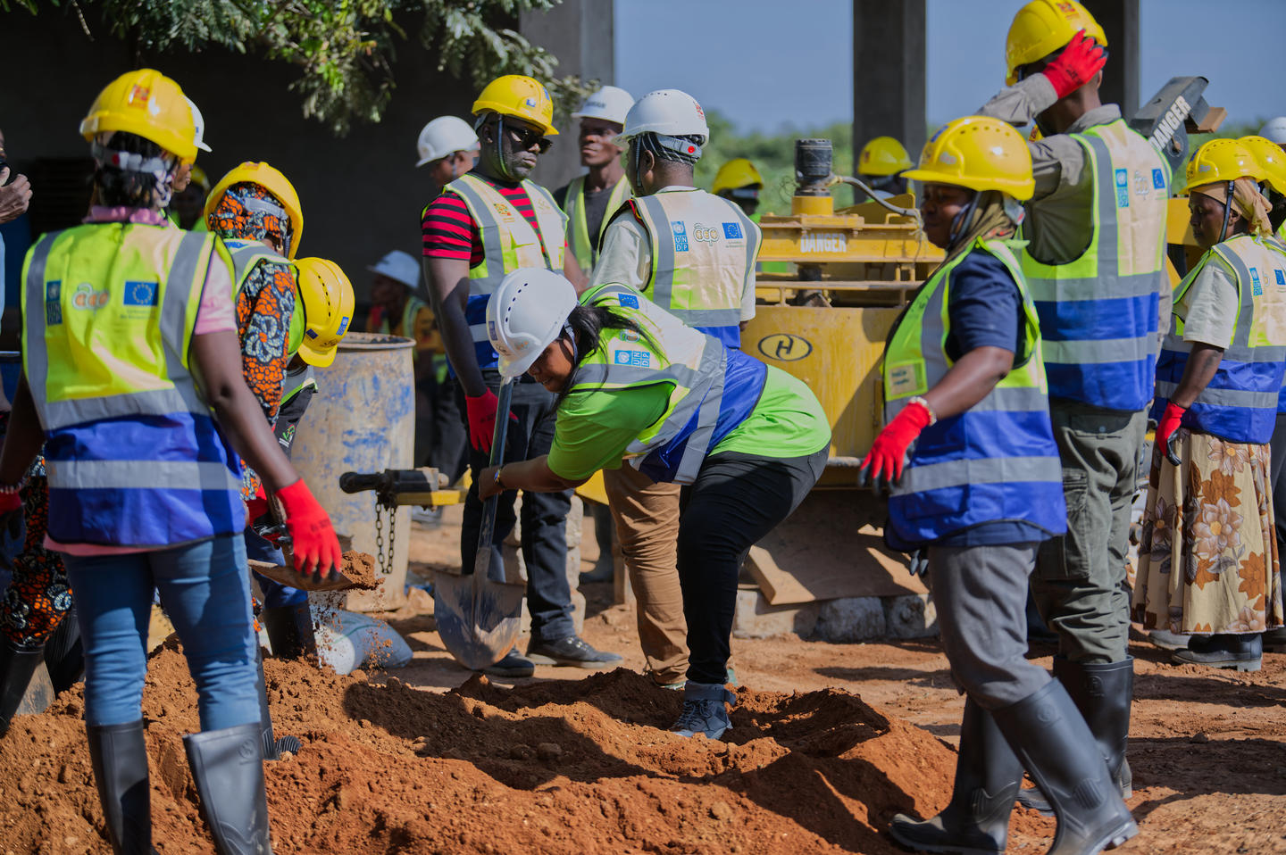 Participants of the ACP-EU Mining Development Programme Regional Training on Low-Carbon Materials and Environmentally Friendly Construction engage in hands-on training on the production of low-carbon bricks at Tawah Vocational Training Centre in Kisarawe, Tanzania.